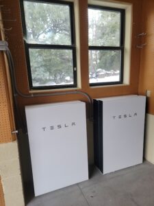 Two Tesla Powerwall home battery systems installed in an Arizona garage for solar energy storage and backup power