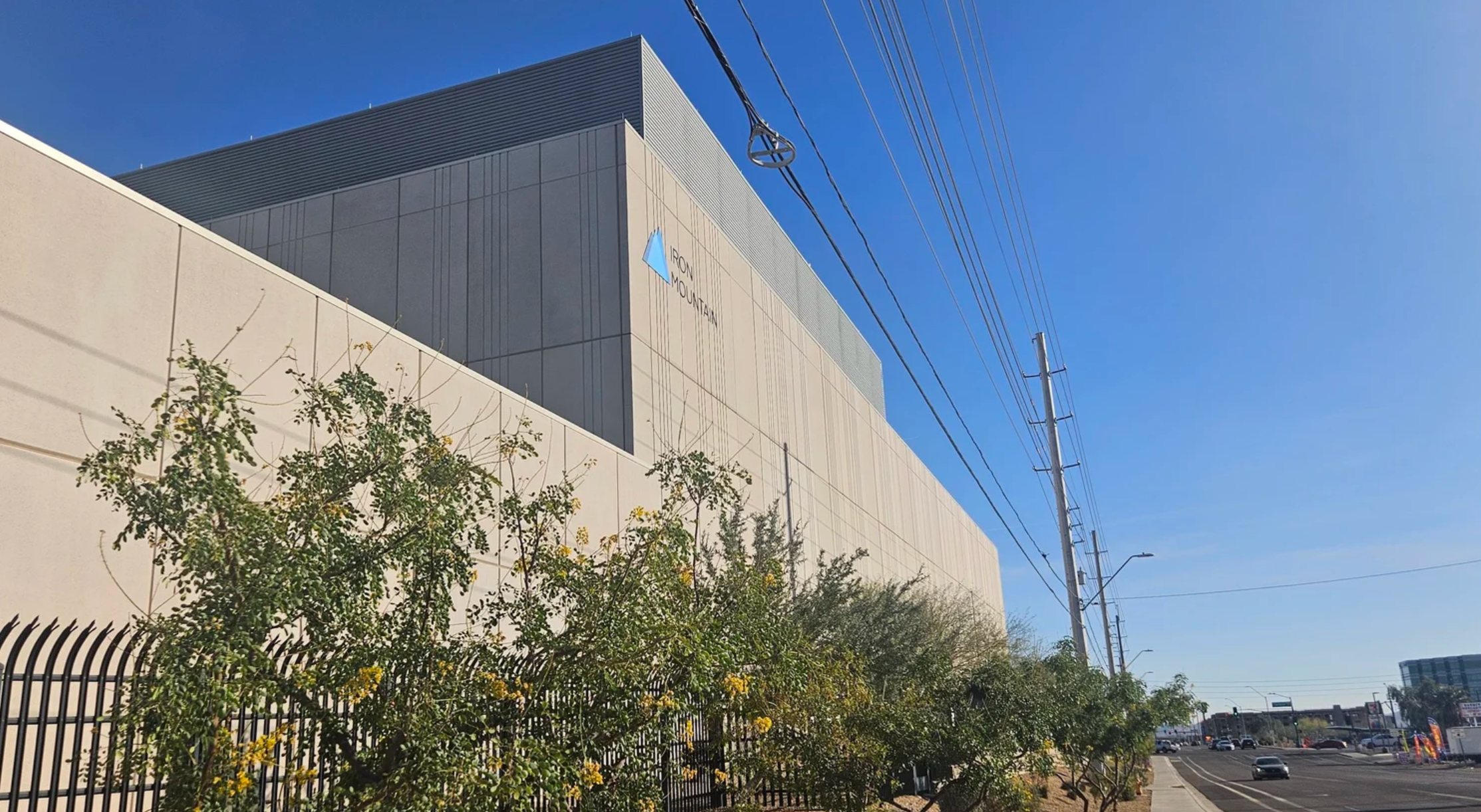 Arizona data center with high-voltage power lines in Phoenix illustrating rising electricity demand and increasing utility rates