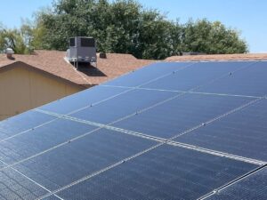 Hyundai 400-watt solar panels on a brown shingle roof in Sun City West, AZ, under a clear blue sky